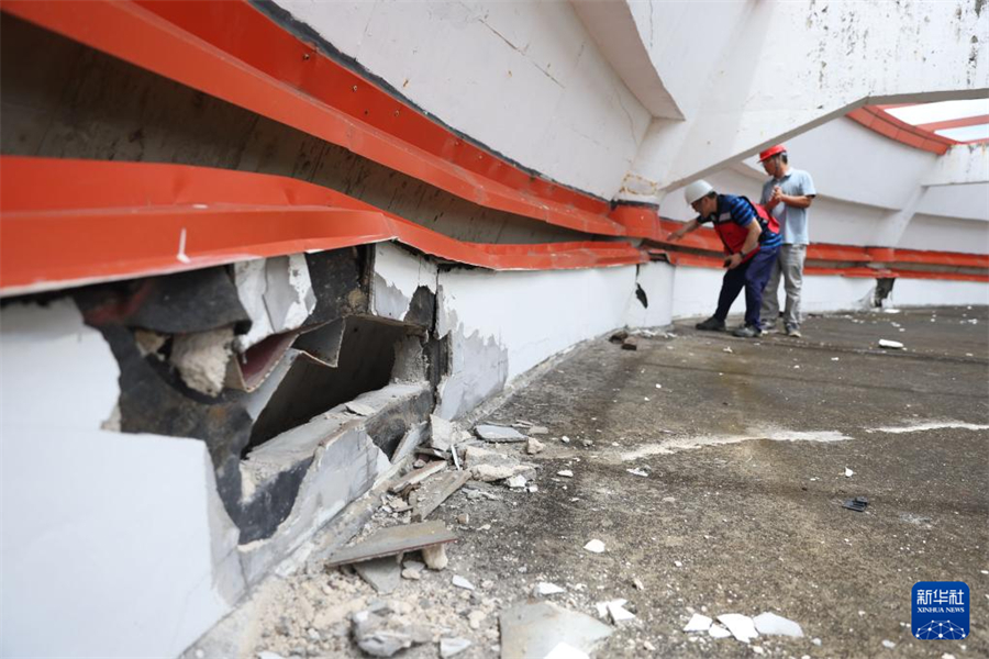 1月1日，在瓦努阿圖維拉港，中國地震局專家組成員查看一棟建筑的受損情況。新華社記者 龍雷 攝